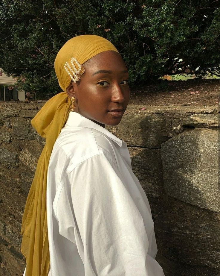 someone with wrap with gold pin accent as one of the cute headwrap styles for bad hair days