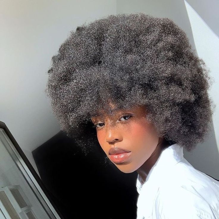 someone with afro hair in her afro hair journey