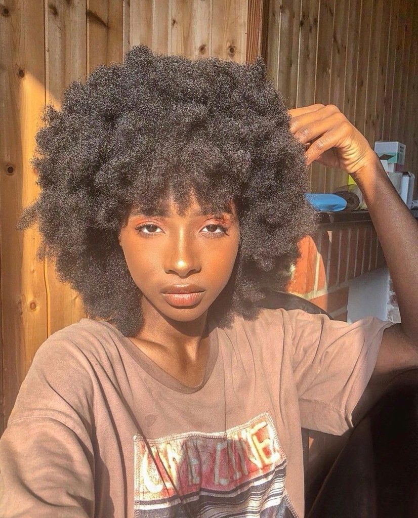 someone with meduium-length afro hair