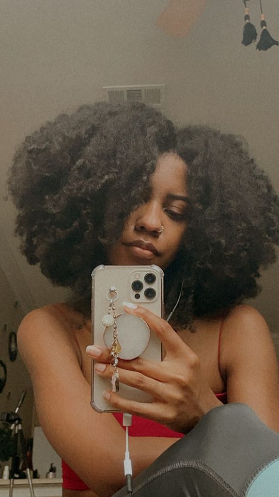 someone showing off her natural hair as one of the ways to stop comparing your hair with influencers