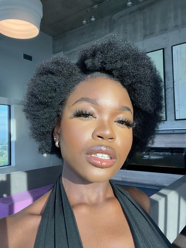 someone with short afro with side part