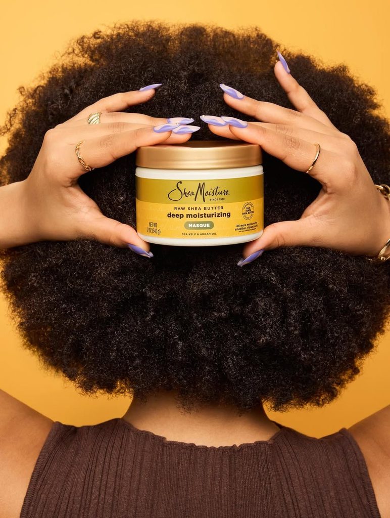 someone with afro deep moisturizer