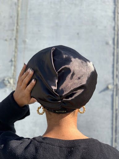 someone covered her hair with hair cap as part of healthy hair routine ideas