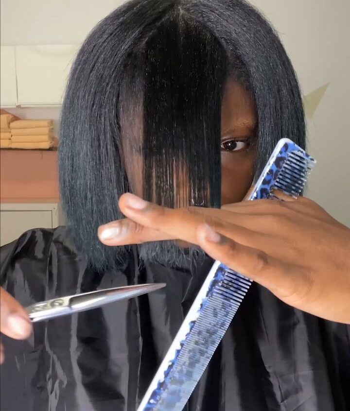 someone trimming her hair