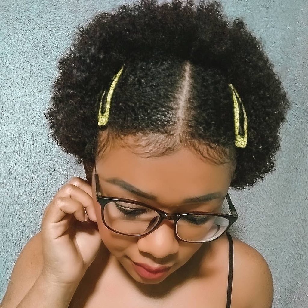 someone with afro hair with pins as one of the ways to style awkward-length natural hair