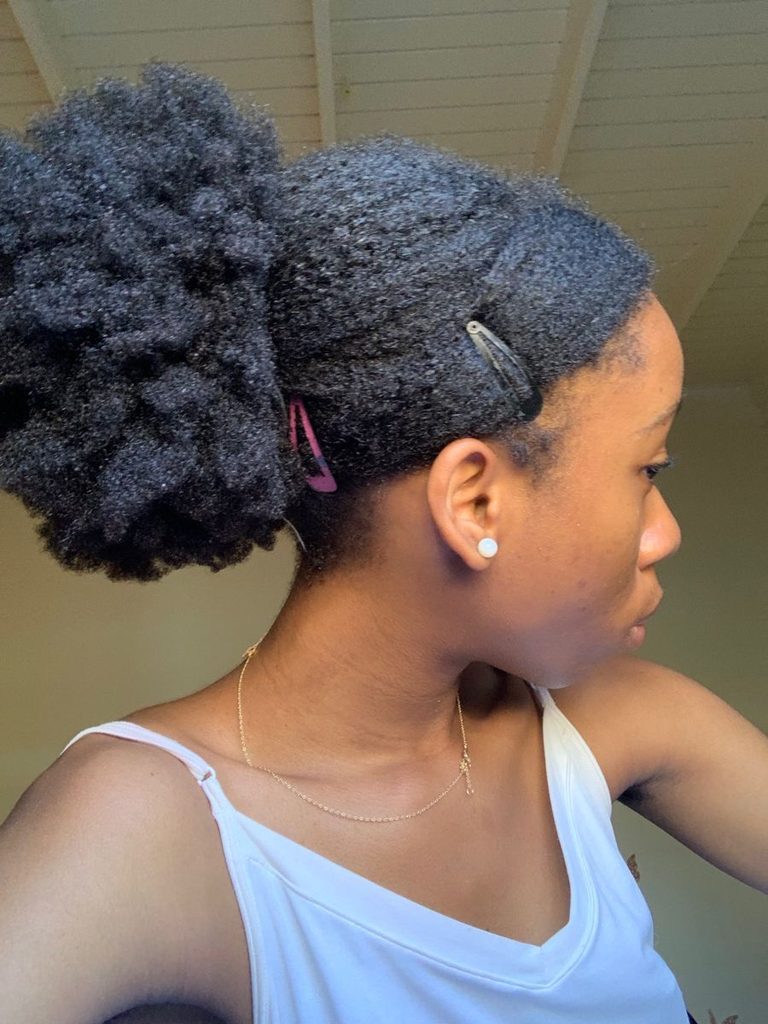 someone with low puff and clips in her afro hair journey