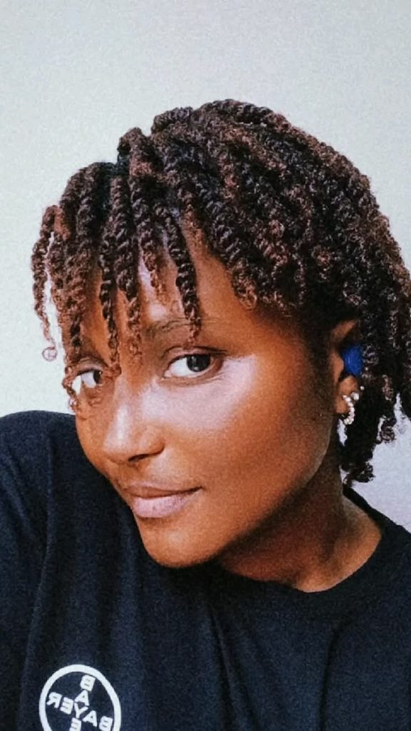 someone with mini twists as a way to style awkward-length natural hair