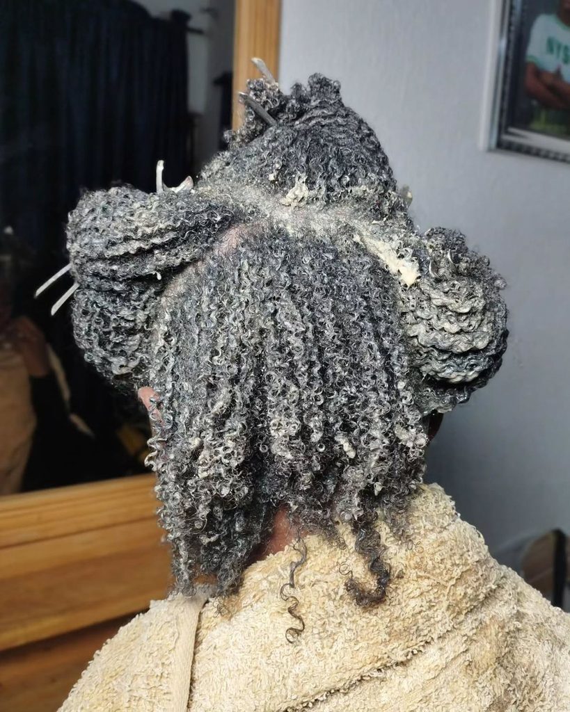 someone that is moisturizing her afro