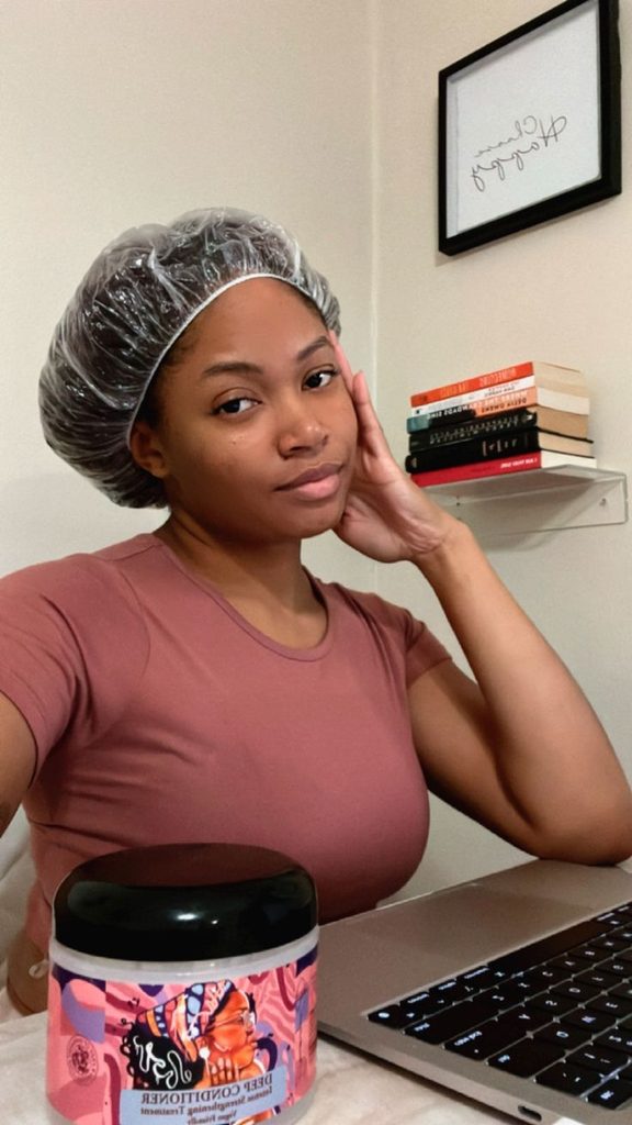 someone at work with her DIY hair conditioning treatment for afro hair