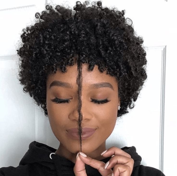 someone with short curly hair growing out a TWA