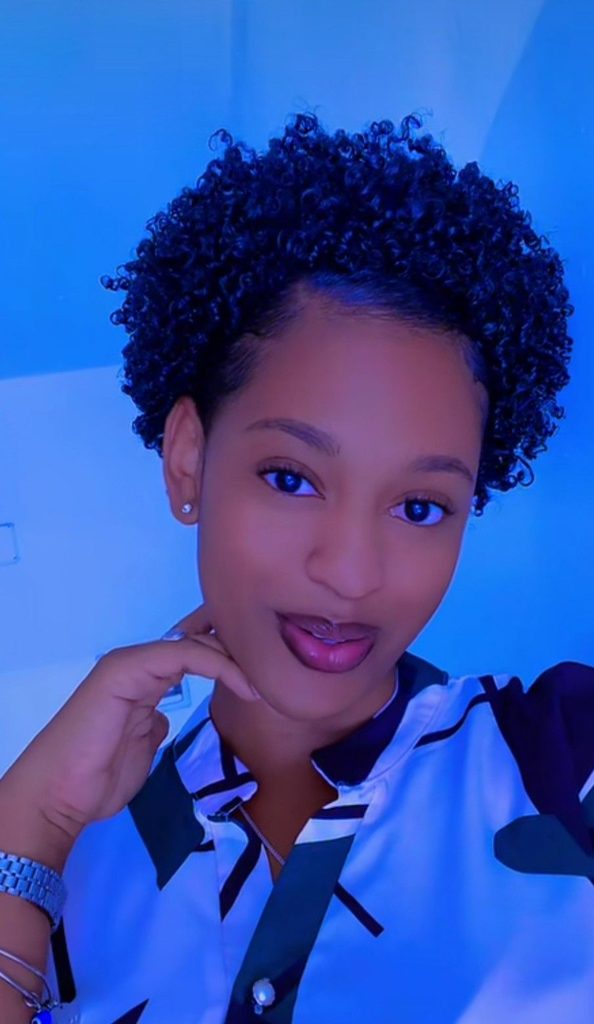 someone in short hair with a well laid edges growing out a TWA