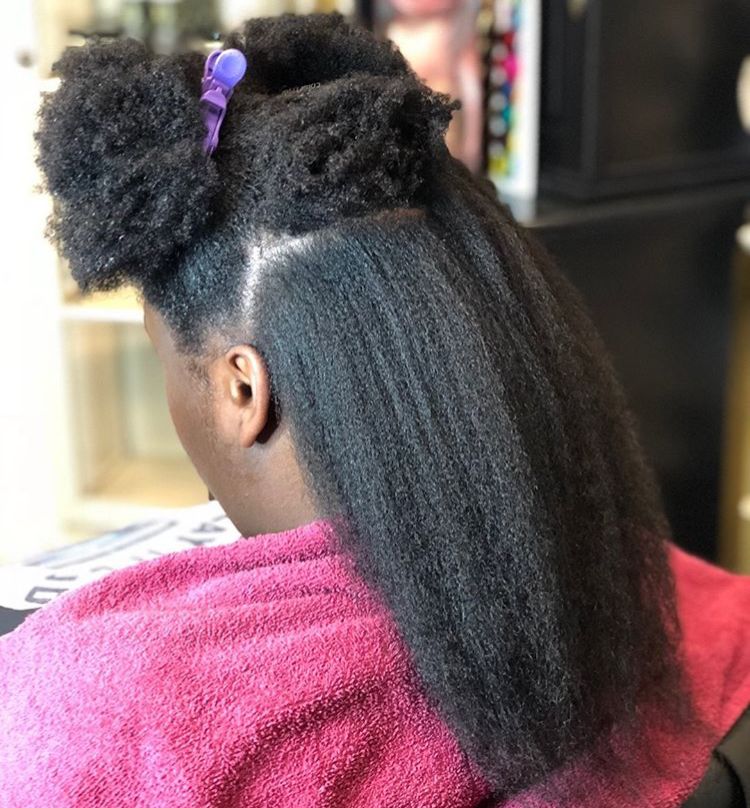 someone stretching her afro hair