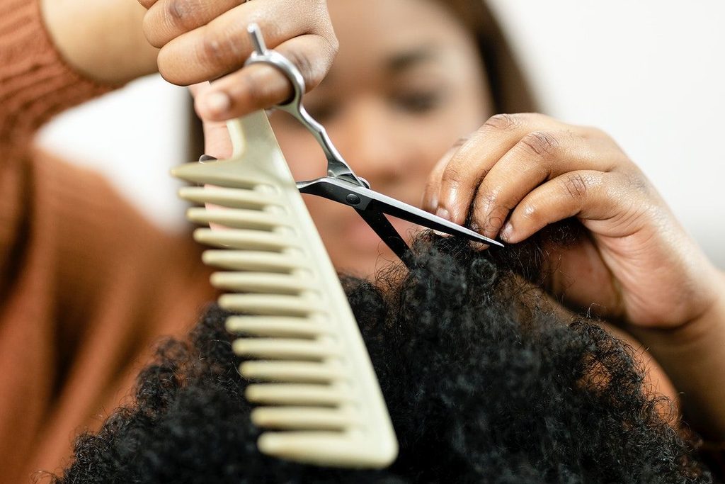 someone getting her hair trimmed