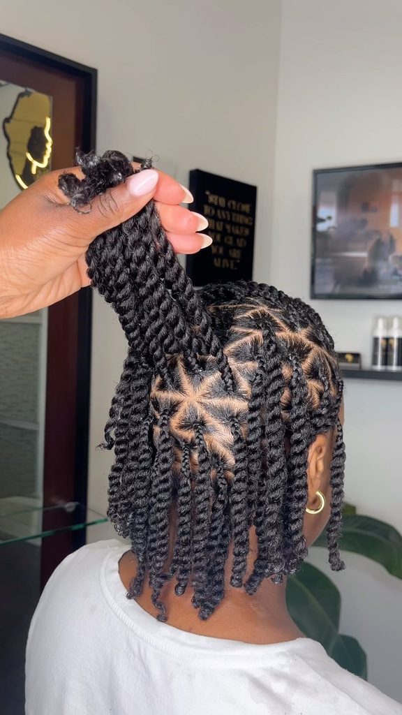 someone with twists style as a way to protect afro hair from humidity
